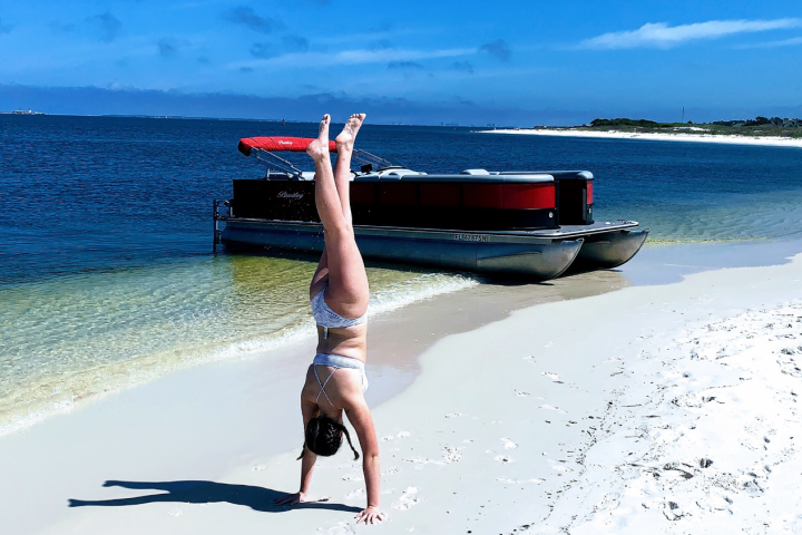 Pontoon Tritoon Boat beached at Sand Island frisky boat tours